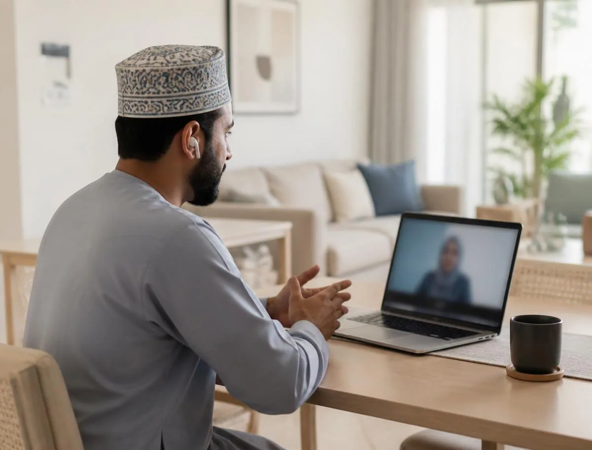 Patient at home in Oman joining a secure video consultation on a laptop